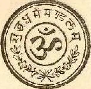 Sello del Suddha Dharma Mandalam: la sílaba OM en doble anillo, con la leyenda devanagari शुद्ध धर्म मंडलम en el borde y laurel abajo.
